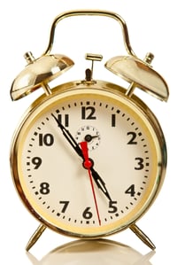 Golden alarm clock - isolated over a white background