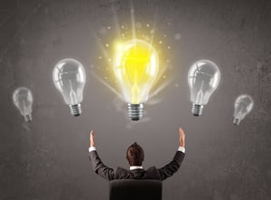 Business person having an bright idea from idea generation and structured innovation - light bulb concept 